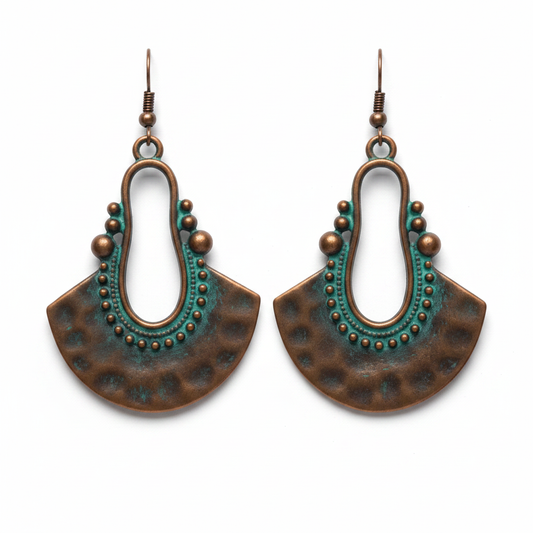 Crescent copper earrings with teal patina arch and beaded detail on white background