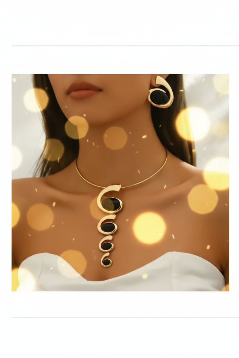 Gold geometric collar necklace with black and gold spiral pendants and matching earring worn on model