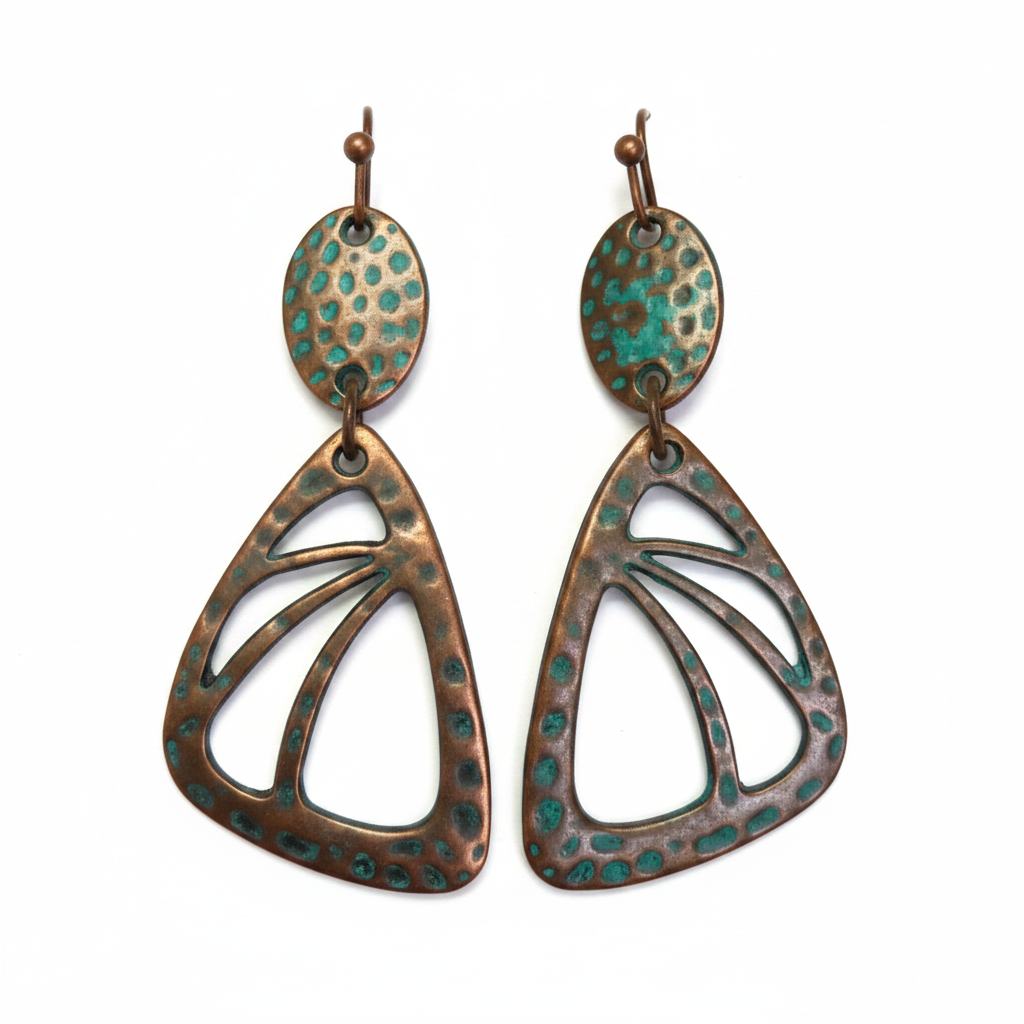Butterfly wing-shaped copper earrings with iridescent teal stone on white background