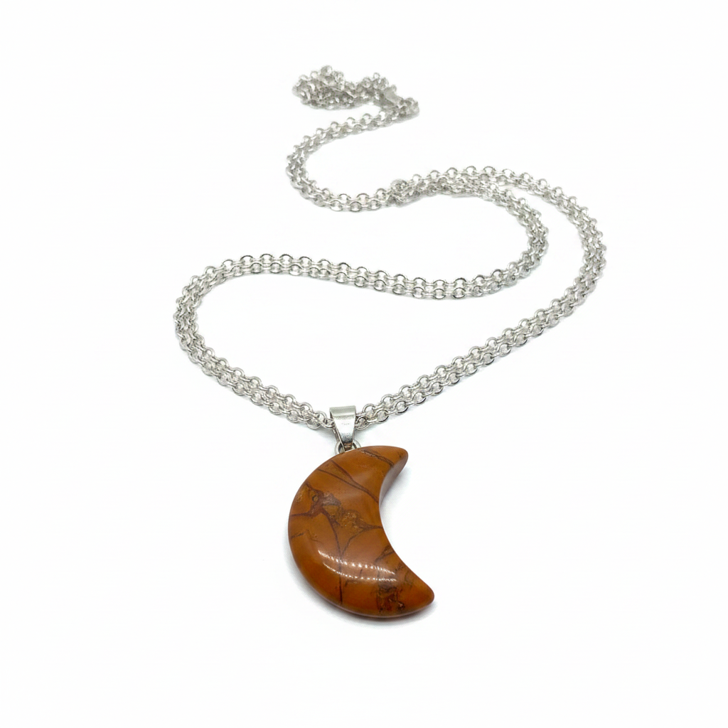 Orange jasper crescent moon necklace with warm orange natural stone pendant on silver chain, white background