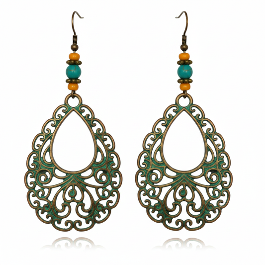 Large teardrop copper-green filigree earrings with teal bead on white background