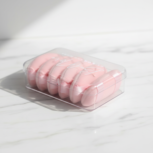 BeMore Puff Pads - triangular pink puff pads in clear box on marble